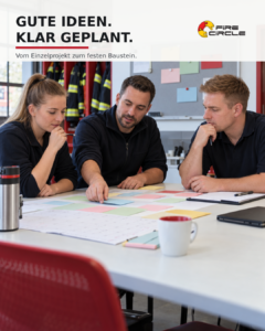 Drei Feuerwehrangehörige planen gemeinsam ein Ehrenamtsprojekt im Feuerwehrhaus.
